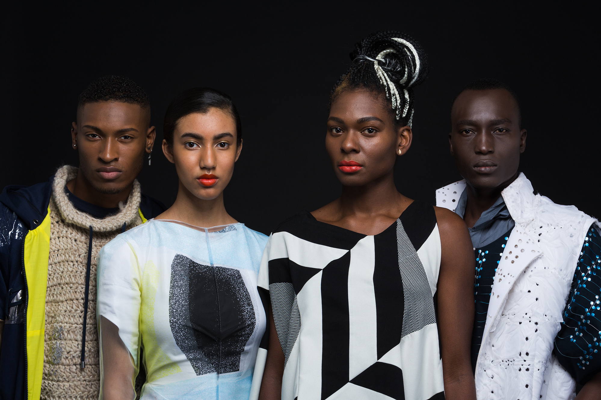 portraits of models wearing FAD creations against a black background